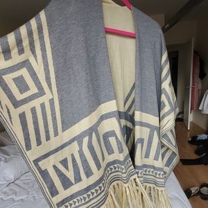 Oversized weater poncho with fringe detail